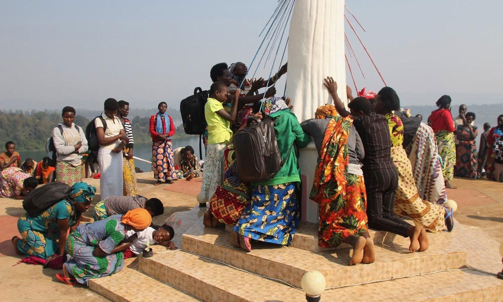 crowd praying at Divine Mercy statue